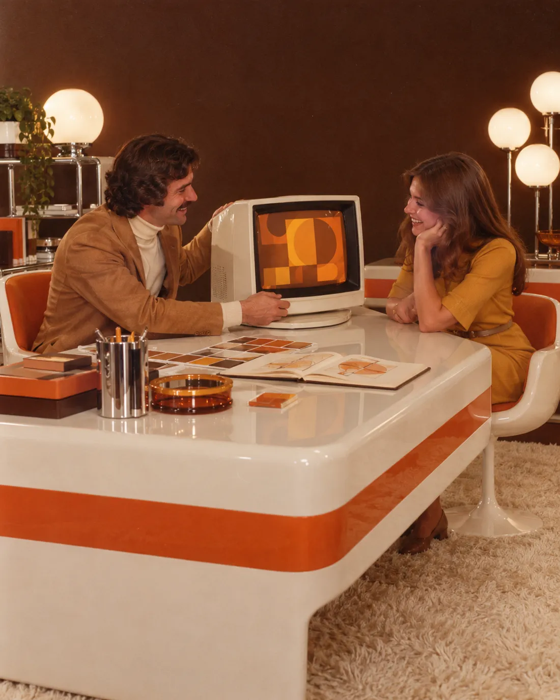 A designer showing a client her new brand on a retro computer